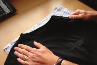 Iron Place a smooth cloth between the T-shirt and a solid surface.