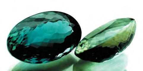 Figure 4. Both of these beryls (30.67 ct and 23.64 ct) show a strong green-blue color when viewed face-up parallel to the optic axis (left).