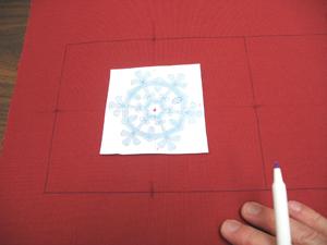 Poke a hole in the center of the template and align it with the center point on the fabric.
