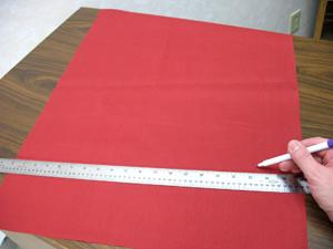 To begin, prepare the large gift wrap pocket. Cut a piece of the solid-colored canvas 20 inches wide by 26 inches high.