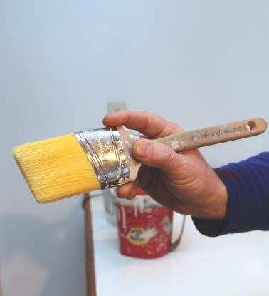 For close-in detail work, such as cutting in interior trim, I choke up my grip on the brush, with my finger tips gripping the metal ferrule close to the bristles (1).