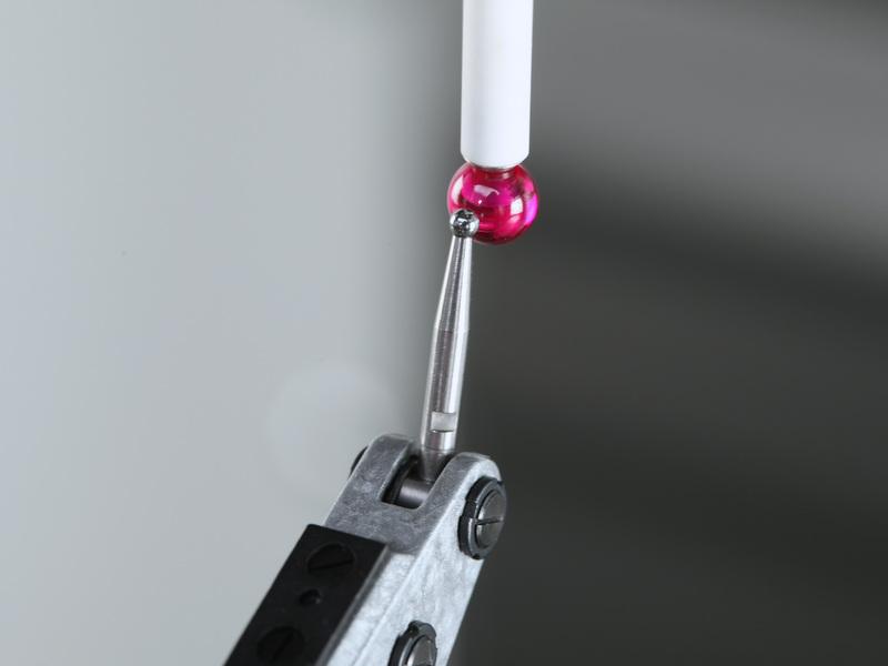 Place the magnetic base on the table and align the indicator tip to the probe's stylus.