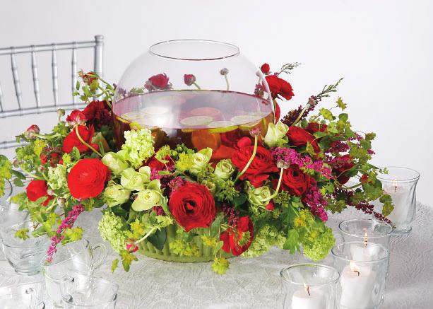 An oversize utility bowl provides a solid vessel for a substantial floral base beneath a punch bowl.