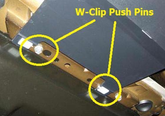 i. While under the vehicle locate the 2 bottom center W-Clip Fasters at the rear center of the valance. Remove these with a forked push pin tool. (Figure 7). j.