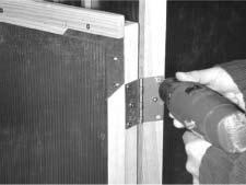 Locate the lower door panel and position the panel in the door opening and attach the hinges as described in the previous step.