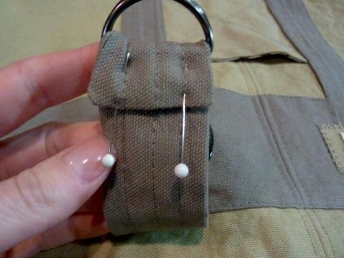 Bring the finished end around to the back of the strap approximately 1" and pin