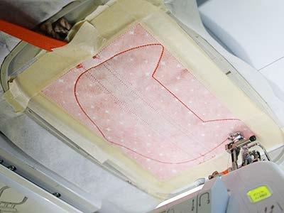Place the hoop back onto the machine, and embroider the final "finishing seam step.