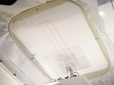 Load the back embroidery file (file "a") onto the machine, and begin to embroider the design. The first thing to sew will be the "zipper dieline".