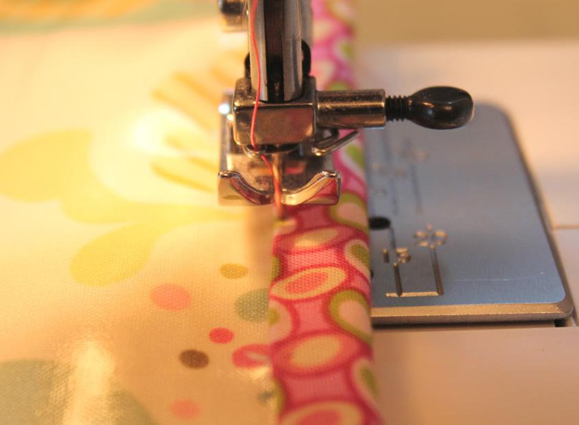 Fold the binding down over the raw edge of the quilt and press with your