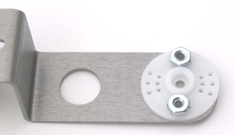 19. Using (2) #4 - ¼ screws, lock washers and nuts, install the round servo arm to the front foot as