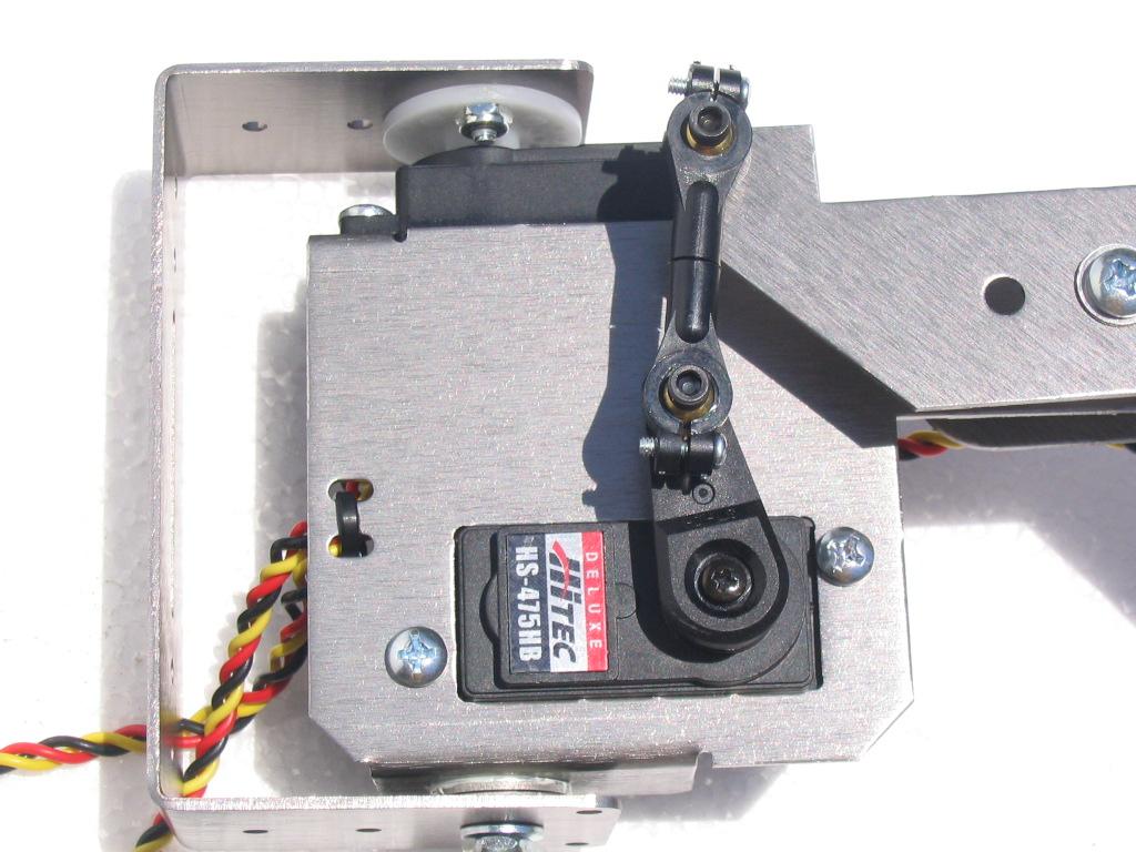30. Using the servo arm screw for the Hi-Tec 475 HB servo, install the servo horn to the vertical lift servo in the 11:00 o clock position as shown in figure 32.