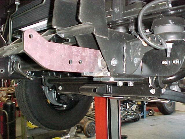 4. Once the brace assemblies are in position, (with the fasteners installed at the top of the bumper perches) drill completely through the inside wall of the bumper perches and the large rectangular