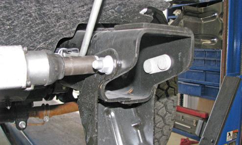 Using an 18MM socket, remove the two bolts on each side of the bumper support.