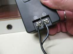 Attach the Power Supply: Prepare the Plug s wire to attach to the screws of the Power Supply.