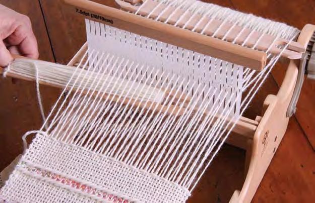 Slide the pick up stick to the back of the loom.