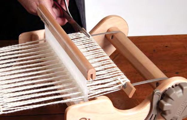 Release the front pawl and unwind the weaving from the front roller.