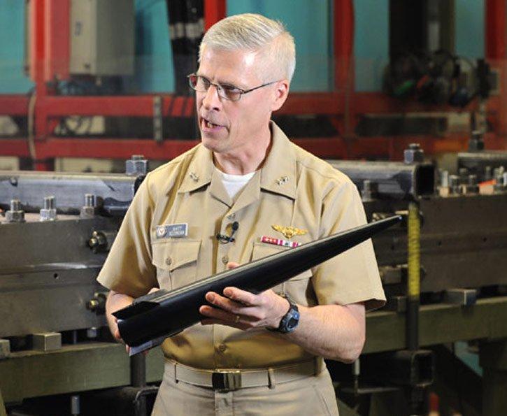 Rear Adm. Matthew Klunder, chief of naval research, shows the Hypervelocity Projectile (HVP).