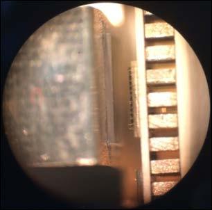 (b) A close-up of the VCSEL and microlens arrays as seen through the microscope. The gap between them is about 0.75 mm. Figure 4-22 shows the complete assembled setup in the lab.