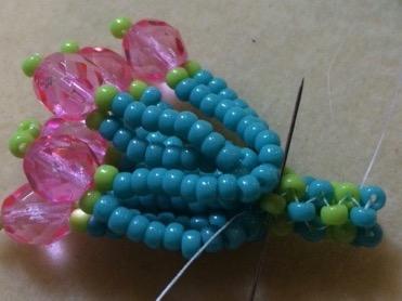 Add another set of loops as in steps 7-9, stitching into the A beads in the base.