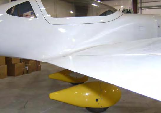 If it does not you must trim the trailing edge of the wing so it will, leaving a very small gap