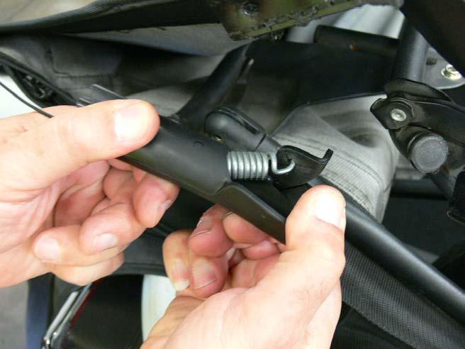Locate the rear side rubber housings where the spring end support cables are protectant in, carefully
