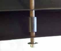 With assistance, stand rods upright with cap nuts at the bottom. Place one vane over all rods.