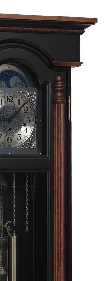 #2003 Bedford Wall Clock Features Flat top with rope moulding around the bottom of the crown moulding Reeded columns with turned ends on door Grooved glass in bottom section of door Hermle triple