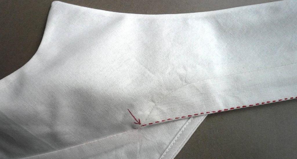 6 Press seam toward collar band. Pin remaining pressed edge of collar band over seam Edgestitch collar band as shown on the photo.