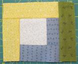 Using the same colour, attach a further strip to the last side of the centre square.