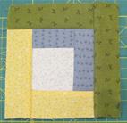 Take the third colour and attach a strip to the next two sides of the central