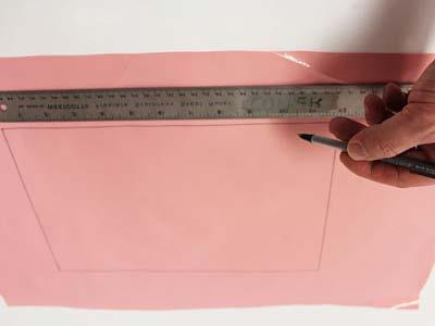 Begin by making the pocket for the apron. Draw a 12" x 8" rectangle on the solid-colored oilcloth.