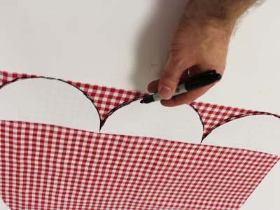 Arrange the pattern pieces along the bottom of the apron so the curved edges line up with the bottom