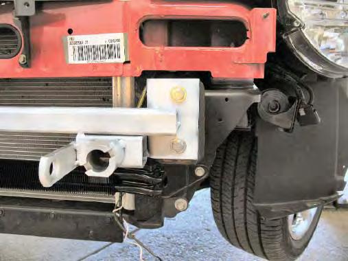 8 8. Using a 15MM socket, remove two metric bolts from the metal bumper. Do this to both sides of the vehicle. Pull metal bumper forward and set aside with the bolts to be reinstalled later. 9.