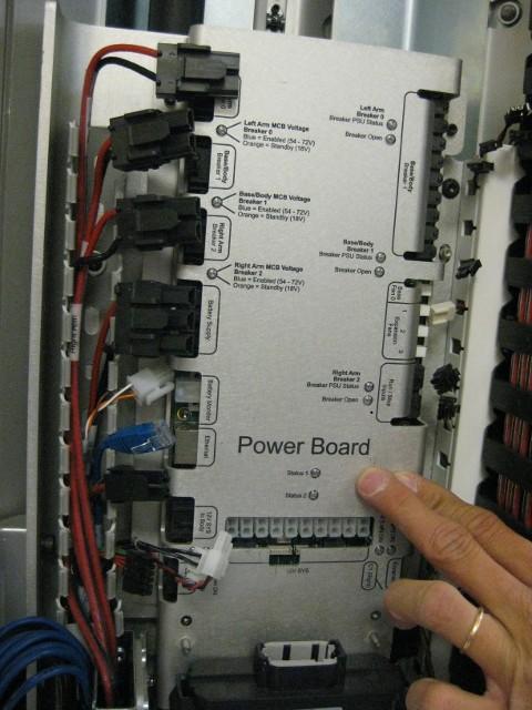 15. Insert power board back into robot. Insert the left side first, and guide the right side in (see Drawing 18). Do not allow any cables to be trapped between the power board and the robot frame.