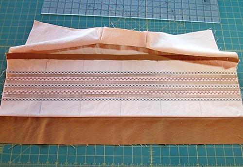 Use a thread that matches the base fabric and you won't notice the pocket seams against the decorative stitching. 8.