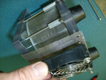 Line up the small piece of stainless mesh with the fan and fan guard.