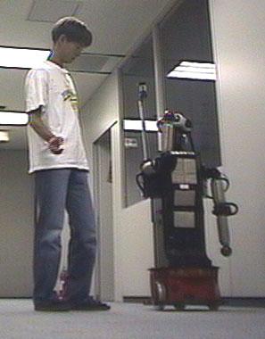C-3: In addition to C-2, the robot turns the eyes to the subject while talking. C-4: The robot stands side by side and directs the body along the hallway.