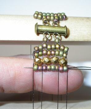 With non-dominant forefinger press the beads upwards to position one bead between the