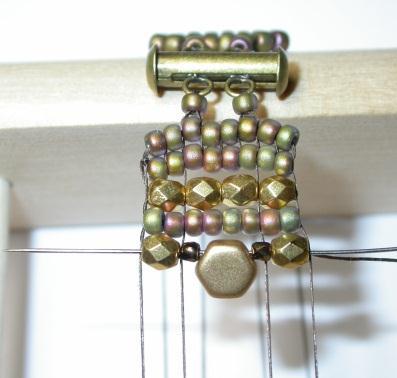 Pass the weaving thread under the warps and slide the seed beads into position as