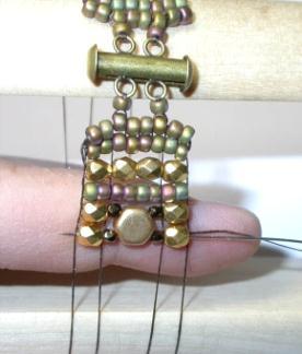 Press up on the beads and pass back through the row including the 2 nd hole
