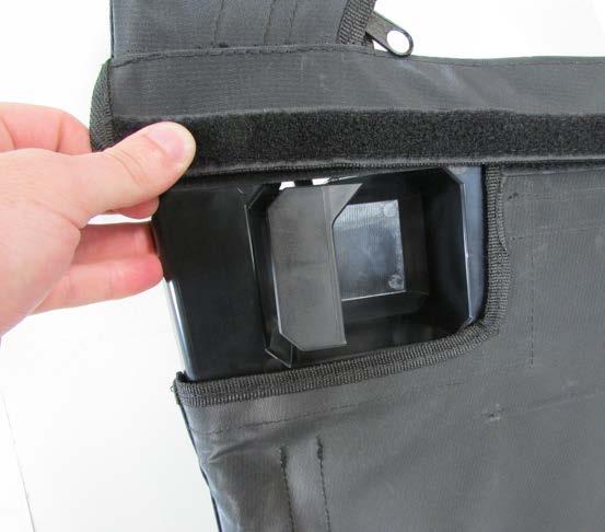 Velcro located on the outside of the lower panel as shown.