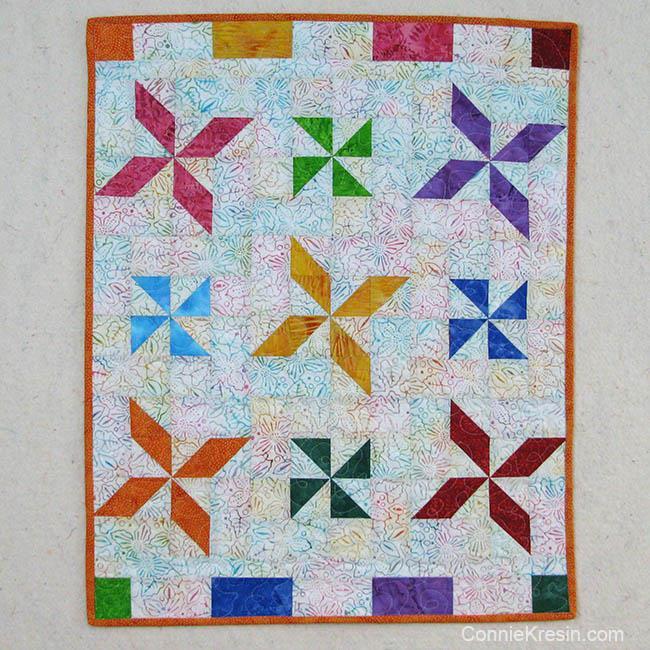 This would make a beautiful fast and easy baby quilt or it could be used as a wall hanging. This could also be used as a table topper, notice the runner below?