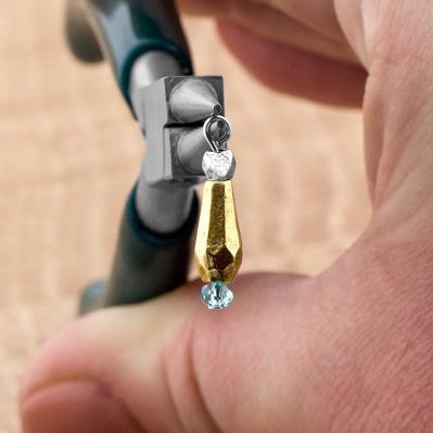 Bend the wire at the top of the bead to a right angle with chain nose pliers or your fingers.