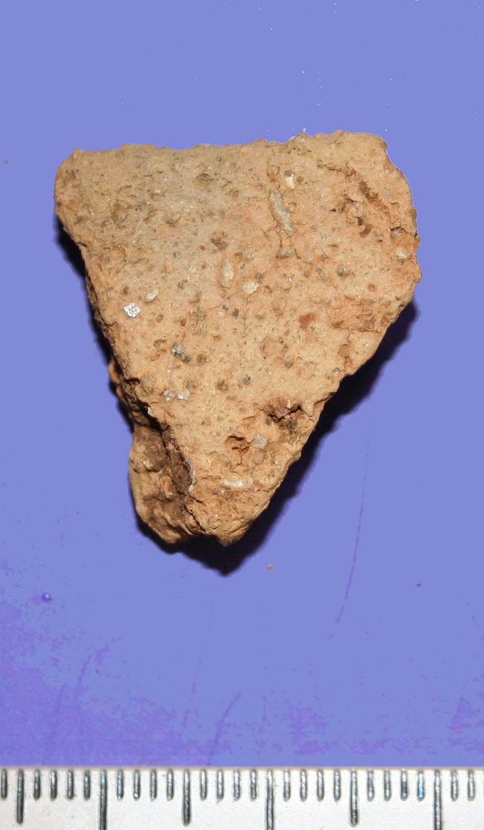 The exterior of the sherds show evidence of wiping. The fabric contains mica inclusions. It is difficult to identify what type of pottery this is or its age. Vessel 6 Single body sherd of pottery.