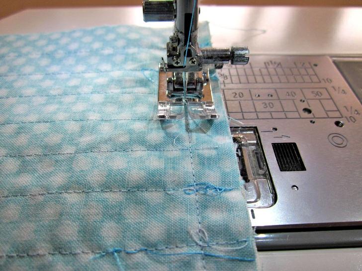 5. Stitch the layers together, sewing with the quilted pocket panel facing up so you can follow along in the rick rack basting seam. 6. Press the seam allowance up toward the cuff. 7.