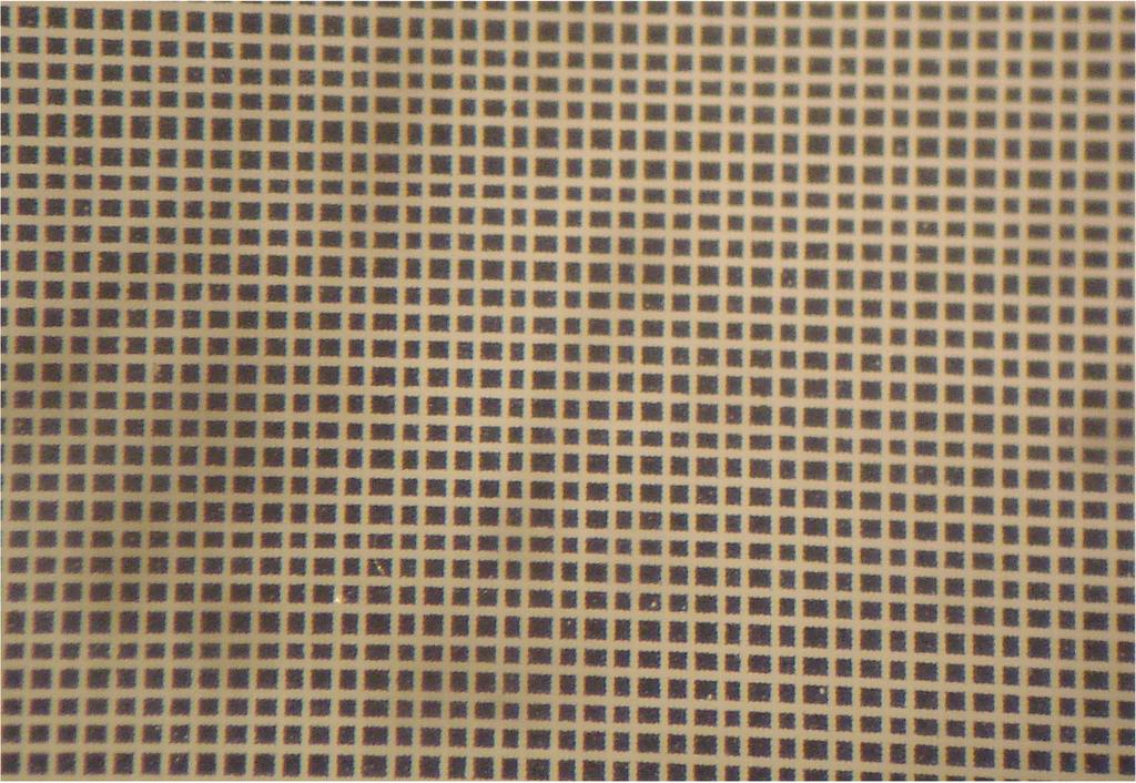 4 Fig. 3 (Color online) Microscope photograph of prototype filter produced by ablating aluminum on Mylar with a galvanometer-mounted ultraviolet laser, achieving 30 µmm features.