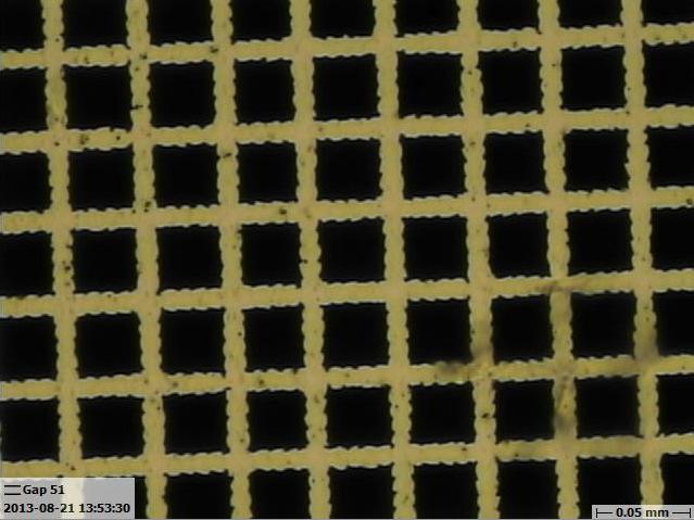 6 Fig. 5 (Color online) Microscope photograph of a capacitive mesh filter produced by ablating aluminum on Mylar with an XY-stage-mounted ultraviolet laser, achieving 15 µm features.