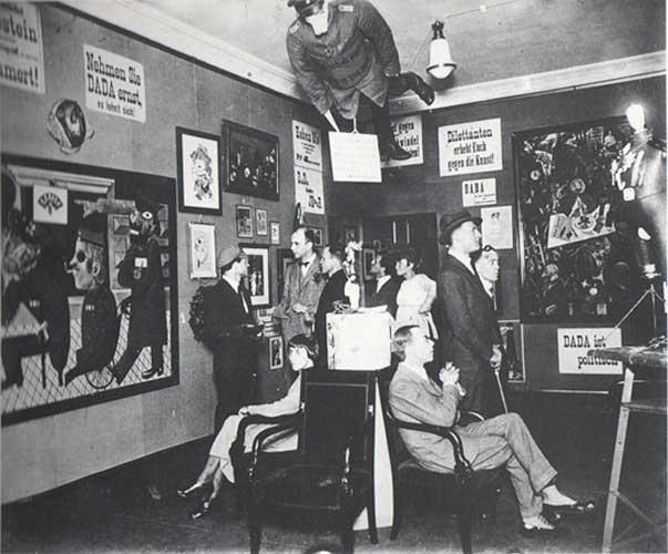 Above, photograph from First International Dada Fair, 1920, featuring