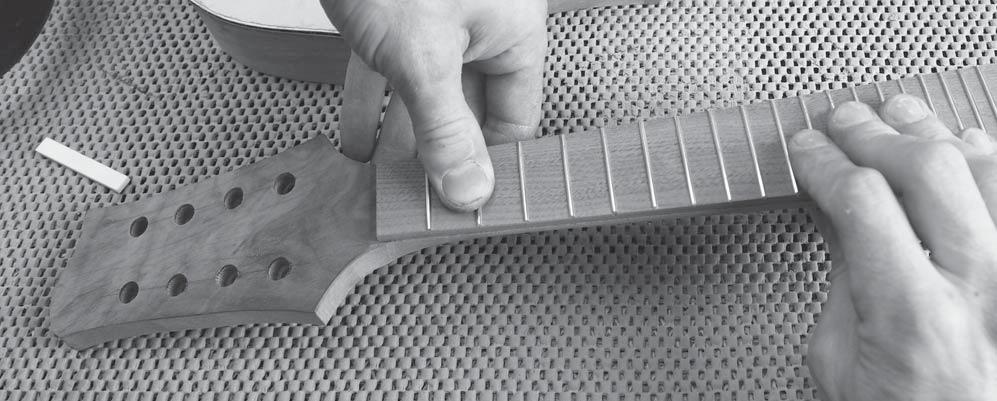 The nails will keep the fingerboard from slipping out of place as you apply clamping pressure.