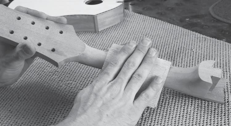 Some people with large fingers prefer to keep the fingerboard full width, but you can trim it narrower if you like by removing equal amounts of wood from each side.